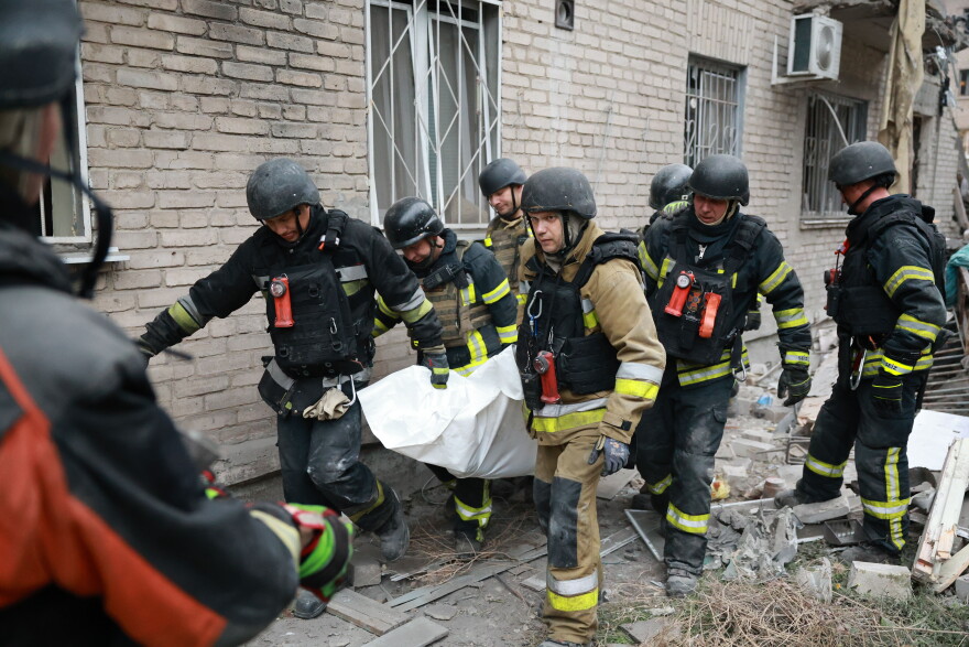 Rescue workers carry a body after pulling from the rubble of a residential building destroyed by a Russian airstrike in Zaporizhzhia, Ukraine, Saturday, Oct. 10, 2026.