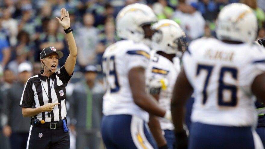 Sarah Johnson makes a call during the first half of an April 2014 preseason NFL football game between the Seattle Seahawks and the San Diego Chargers.