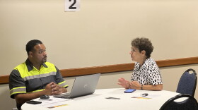 City of East Lansing Department of Public Works employee speaks with resident about summer flooding.