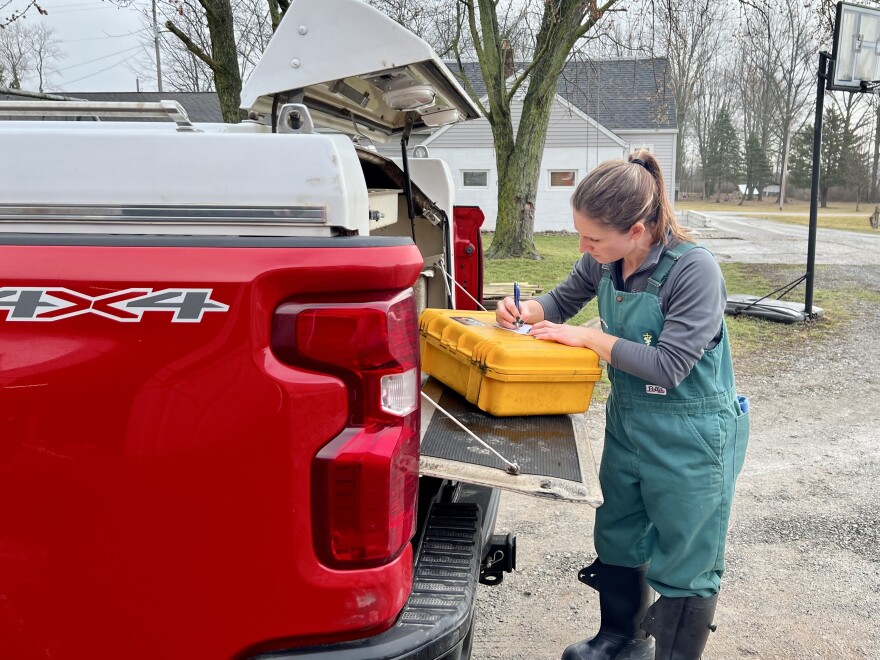 Veterinarian Amanda Wagner writes a prescription on the be