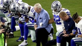 In this Monday, Sept. 25, 2017 file photo, the Dallas Cowboys, led by owner Jerry Jones, center, take a knee prior to the national anthem prior to an NFL football game against the Arizona Cardinals, in Glendale, Ariz.  (Matt York/AP)
