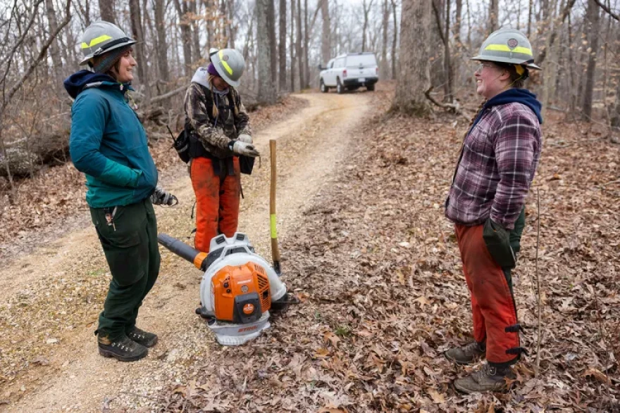 Pen Johnson, Piper Morris and Danielle Cafin stand together as they take a break from preparing a burn unit March 16, 2026, at Trail of Tears State Forest in Jonesboro, Illinois.