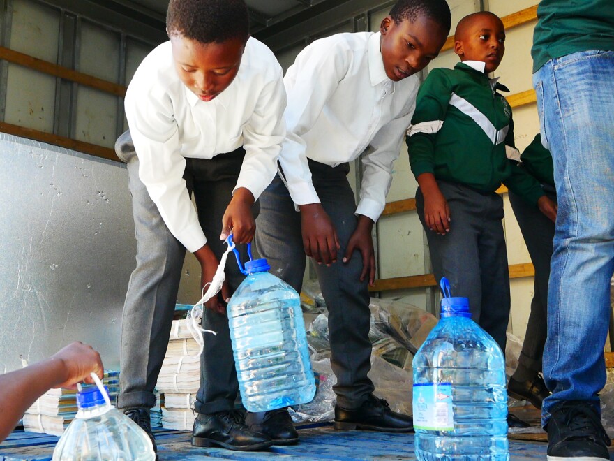 Schoolboys unload donated water at the Isikhokelo Primary School in Khayelitsha township. The principal shut off most taps to keep to tight water restrictions and has told students to bring their own water.