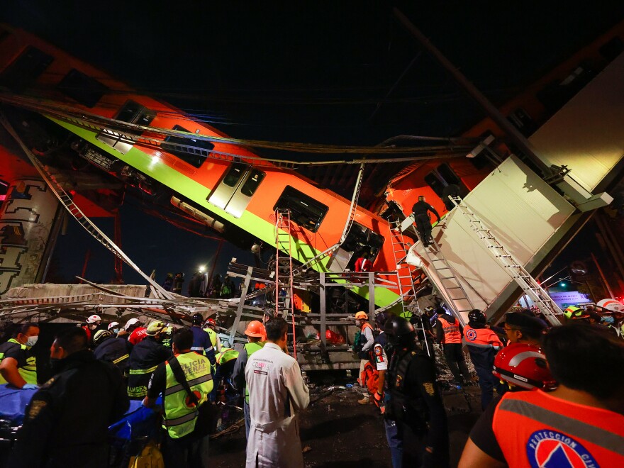 Emergency personnel work to search for accident survivors after a raised subway track collapsed Monday night in Mexico City, Mexico.