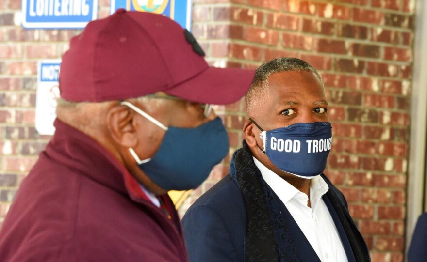 FILE - In this Nov. 3, 2020 file photo, Steve Benjamin, mayor of Columbia, S.C., right, looks on as U.S. House Majority Whip Jim Clyburn, left, speaks with a voter outside a polling place in Columbia, S.C. During a city council meeting on Tuesday, Aug. 3, 2021, Benjamin said that he was considering issuing a new state of emergency for the city, a declaration that he said would allow him to impose mask requirements. (AP Photo/Meg Kinnard, File)