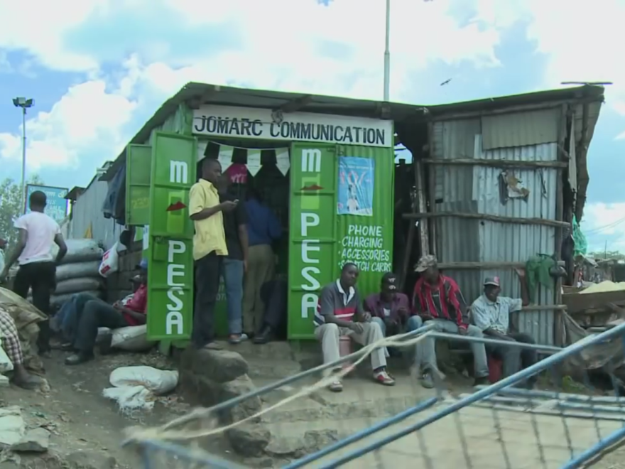 The M-PESA agent who works in this shop is part of a vast network of small-time vendors.