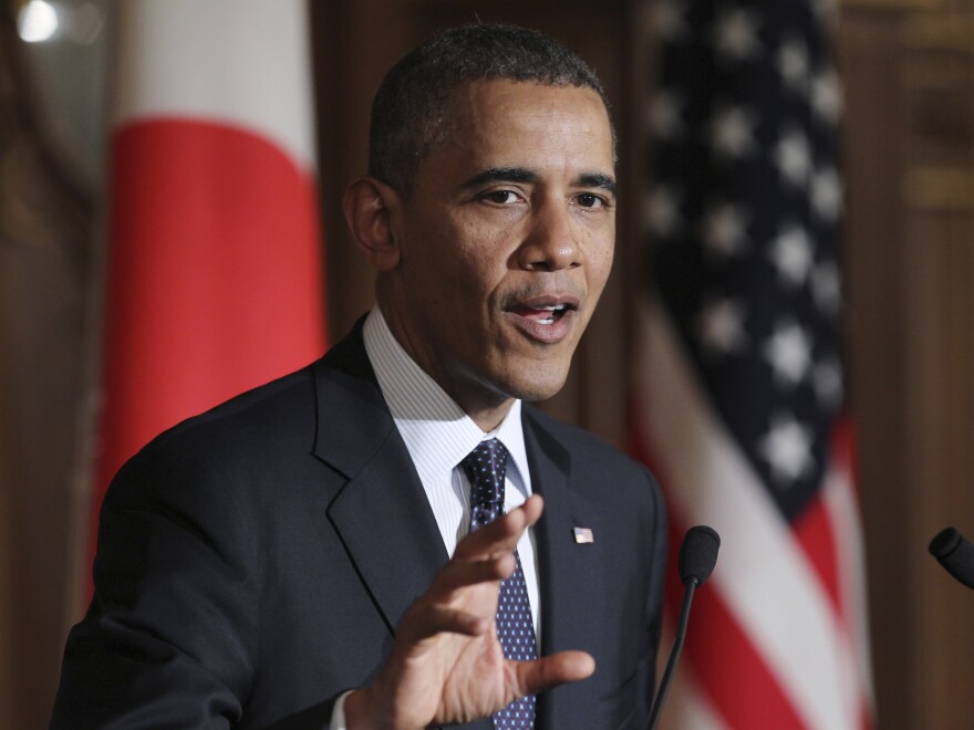 President Obama speaks at a joint news conference with Japan's Prime Minister Shinzo Abe in Tokyo on Thursday. Obama reinforced the U.S.-Japan security commitment.