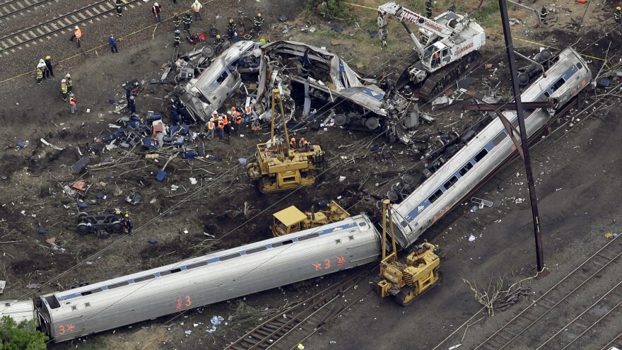 Emergency personnel work at the scene of a deadly train derailment in Philadelphia, which happened on May 12, 2015.