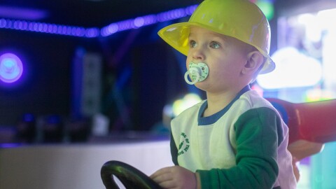 Benjamin Miller plays on a racing game in Play & Party Co.'s gaming room. The gaming room, main room and glam room can all be rented out for parties.