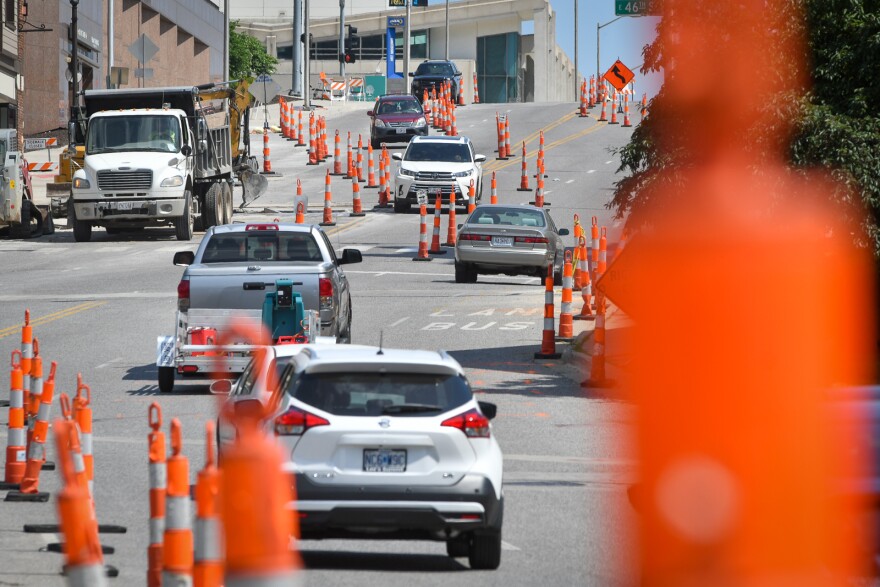 Traffic weaves through the diverted lanes on Main Street near 47th Street on Tuesday.