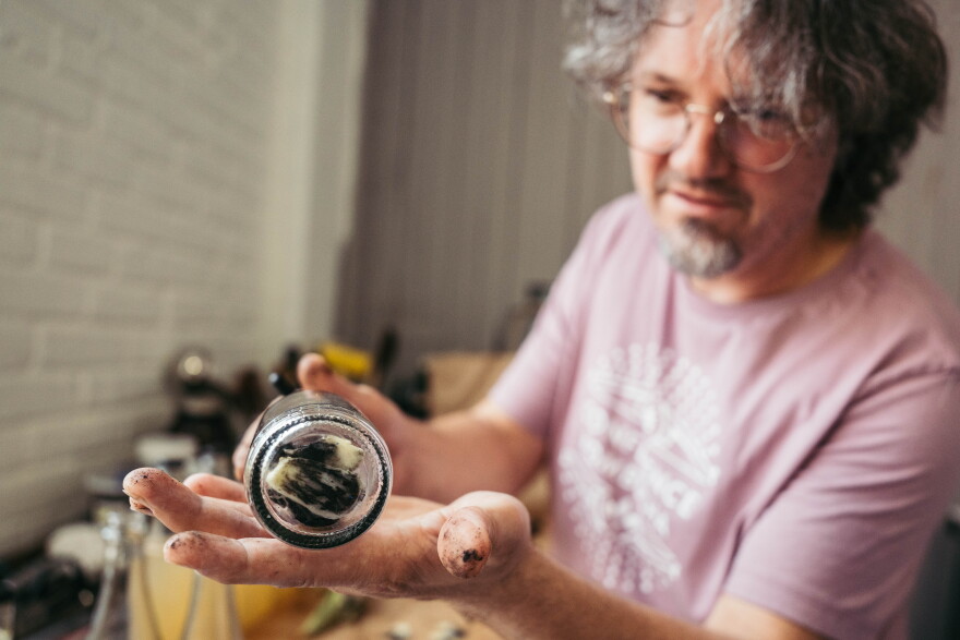 Confluence Kombucha owner William Esslinger shows off a bottle stuffed with huitlacoche.