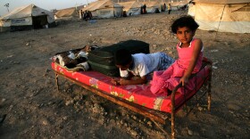 Syrian-Kurdish children sit on a bed at the Quru Gusik refugee camp in the Kurdish region of northern Iraq, on Aug. 22. Faced with brutal violence and soaring prices, thousands of Syrian Kurds have poured into Iraq's autonomous Kurdish region. UNICEF has reported that over one million Syrian children live as refugees in other countries.