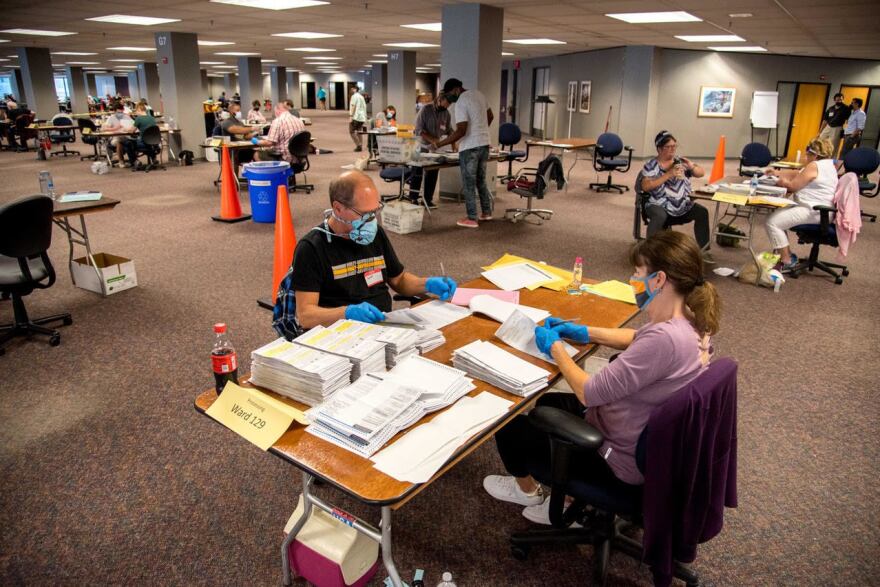 Election workers Jeff and Lori Lutzka process absentee ballots at Milwaukee's "central count" location on August 11, 2020.