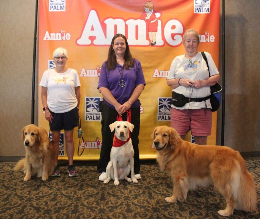 Casey, Teegan and Gritty pose with their owners.