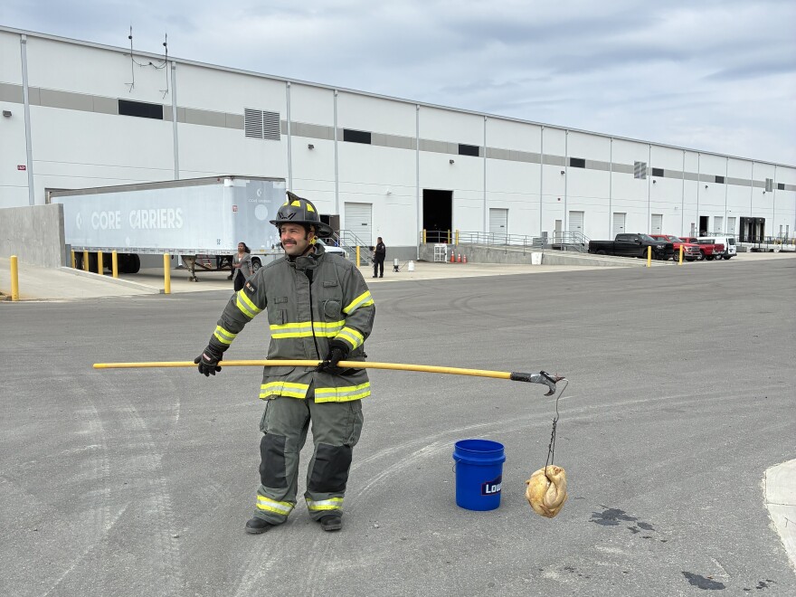 A New Hanover County Firefighter prepares to fry a frozen turkey — a demonstration of what not to do.