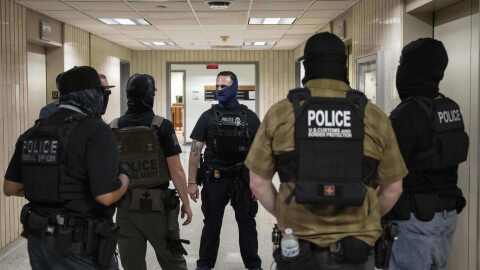 Federal agents stand outside an immigration court at the Jacob K. Javits federal building, Thursday, July 17, 2025, in New York.