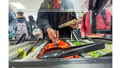 Students get fresh vegetables at the salad bar at York International School, a K-12 public school in Thornton, Oct. 8, 2023. The Healthy School Meals for All has enabled the school to serve more fresh produce through a pilot program that was supposed to go statewide under proposition FF.