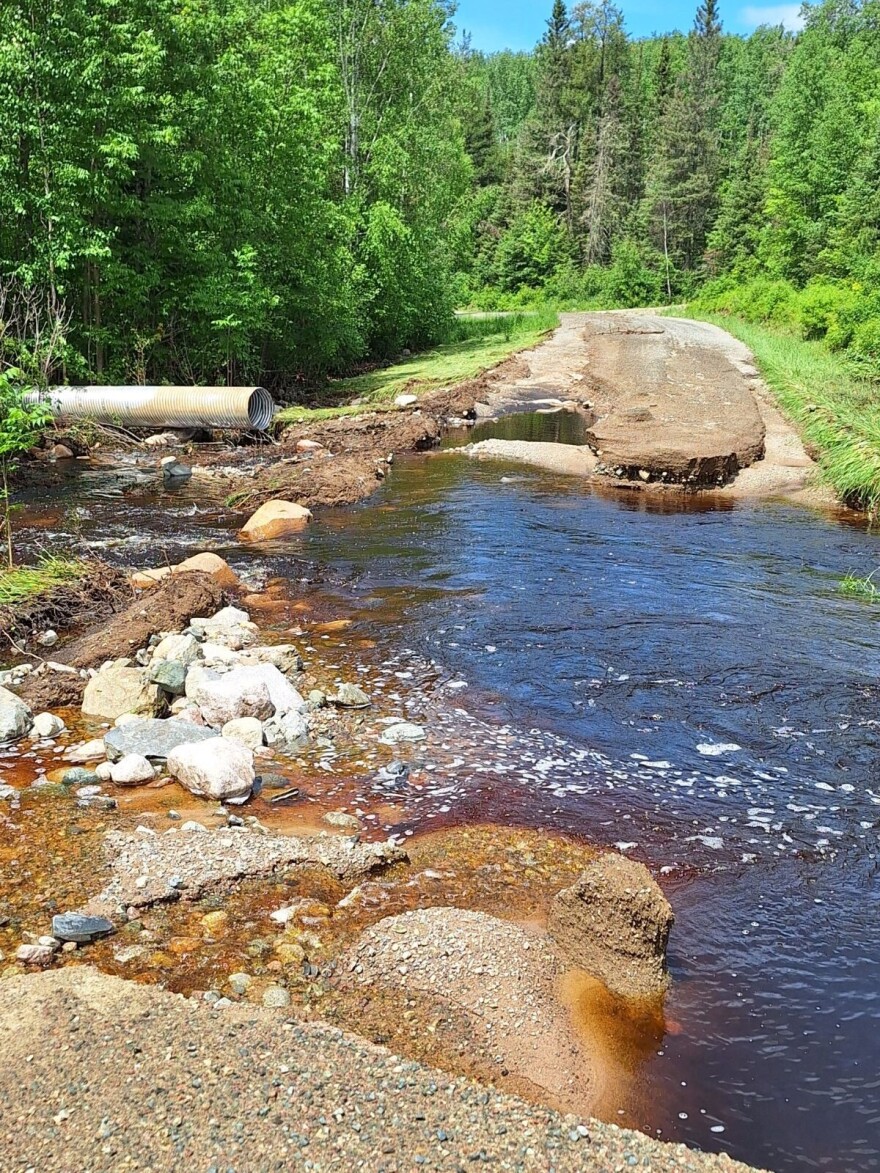 A portion of Mud Creek Road is destroyed by floodwaters Wednesday, June 19, 2024, northeast of Lake Vermilion.
