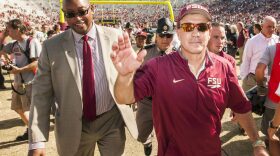 FILE - In this Oct. 17, 2015, file photo, Florida State head coach Jimbo Fisher, right, and athletic director Stan Wilcox walk off the field after an NCAA college football game against Louisville in Tallahassee, Fla. With work on the Champions Club in the south end zone of Doak Campbell Stadium set to be wrapped up by the start of football season, Wilcox's next major priority is renovating the rest of the stadium. (AP Photo/Mark Wallheiser, File)