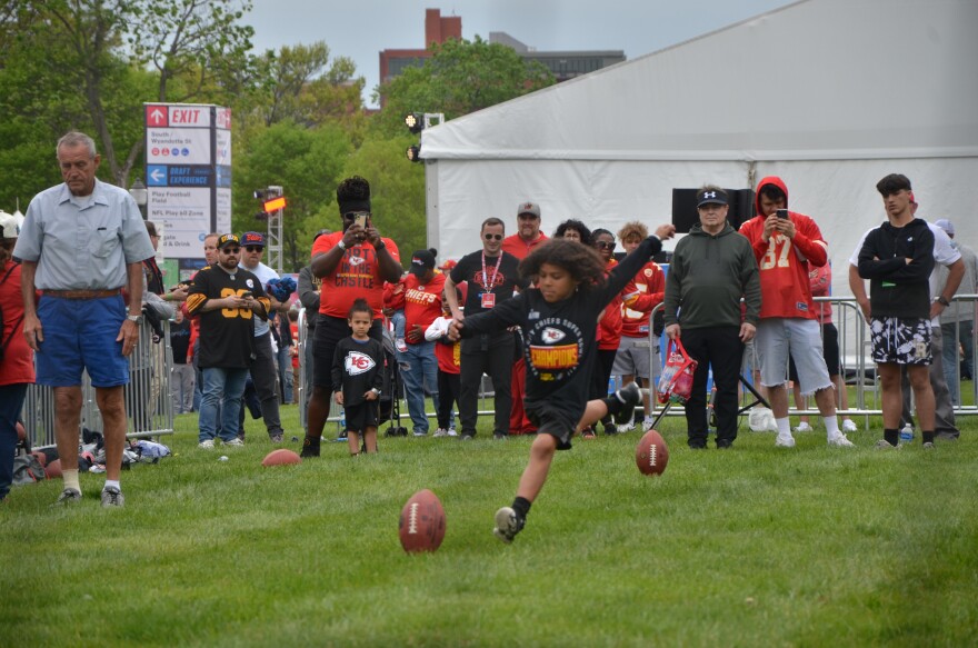  A child in Kansas City Chiefs gears up to kick a field goal