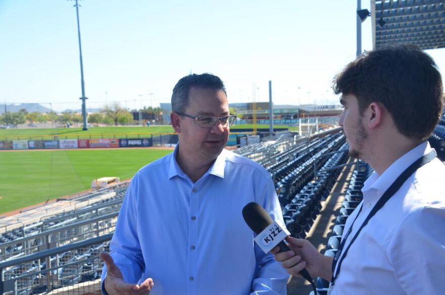 A man being interviewed by a journalism with a microphone