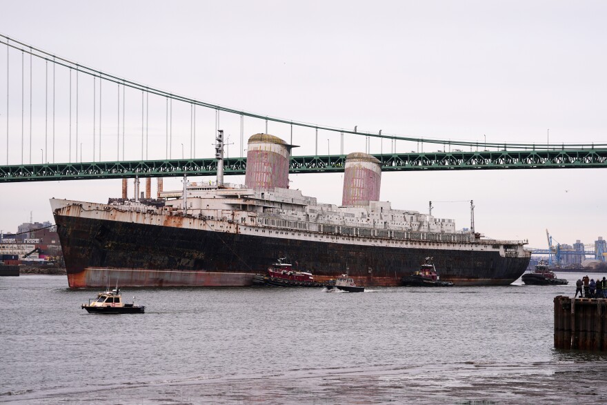 FILE - The SS United States is towed down the Delaware River between Pennsylvania and New Jersey, from Philadelphia, Wednesday, Feb. 19, 2025. (AP Photo/Matt Rourke, File)