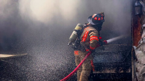 An Evansville firefighter sprays water on a blaze in the 1700 block of Southfield Road, during extreme heat Sept. 2, 2026