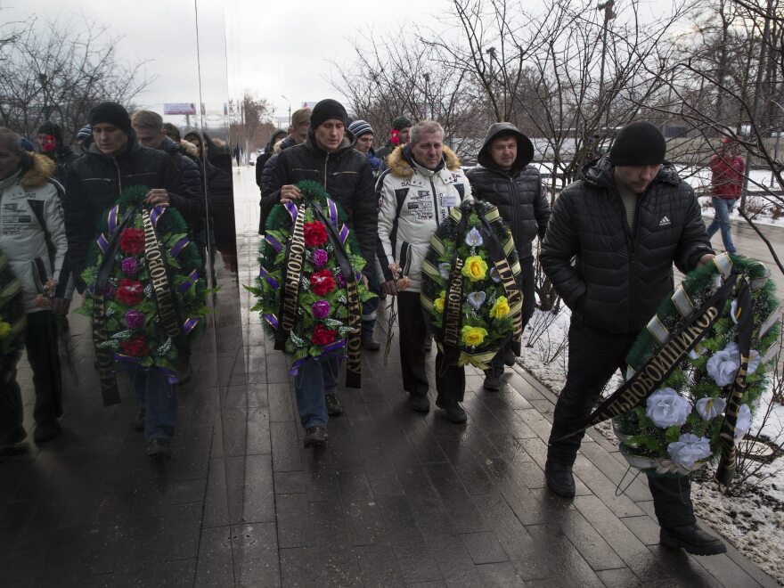 Truck drivers and their supporters walk with symbolic wreaths, which they plan to lay near an office of a new road payment system, outside Moscow on Dec. 13. Truck drivers have been protesting the new road toll for weeks.