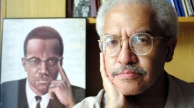 In his career, Manning Marable wrote about the struggle for equal rights — and especially the life of Malcolm X. In this file photo from 2001, he posed at his Columbia University office in New York.