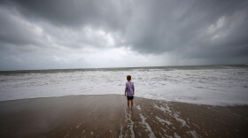  Weston Lee, of Vero Beach, stands near the high surf from the Atlantic Ocean.