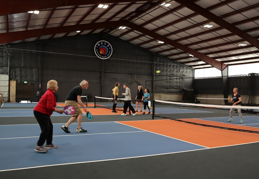 Pickleball enthusiasts practice and take classes at RECS, a new indoor pickleball complex in Clackamas, Oregon, that is drawing players from a wide bistate area.