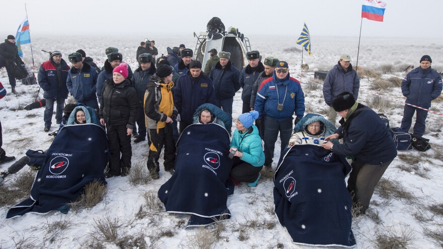 Expedition 42 Cosmonauts Elena Serova (left) and Alexander Samokutyaev (center) sit in chairs along with NASA astronaut Barry Wilmore minutes after they landed back on Earth.