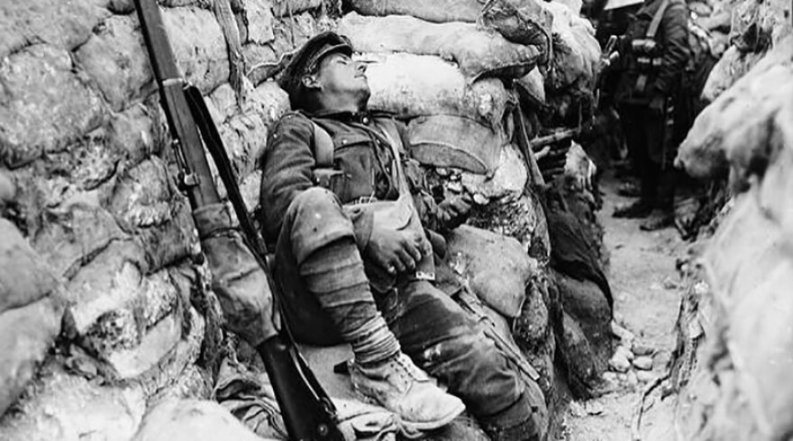 Soldier's comrades watching him as he sleeps, Thievpal, France, during World War I.