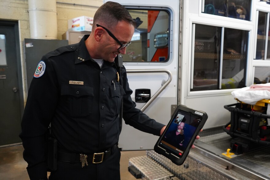 EMS Chief Mehmet Barzev holds an iPad equipped with video remote interpreting technology, provided by Lehigh Valley Health Network.