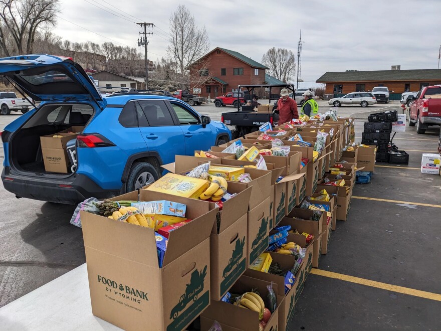 A car gets loaded up with a box of food at a Food Bank of Wyoming mobile food pantry in Pinedale last year.