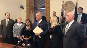 Baby box supporters, led by Sen. Travis Holdman (R-Markle), center, discuss the baby box expansion bill at the start of the 2018 session.