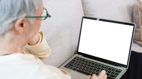This stock image shows a female senior citizen using a laptop computer.