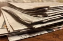 A stack of newspapers is pictured at the Illinois State Capitol.