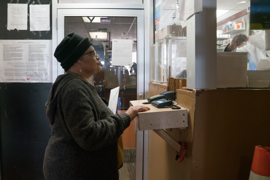 Pauletta Jackson drops off her prescription for Suboxone at the pharmacy just downstairs from Chapman's clinic.