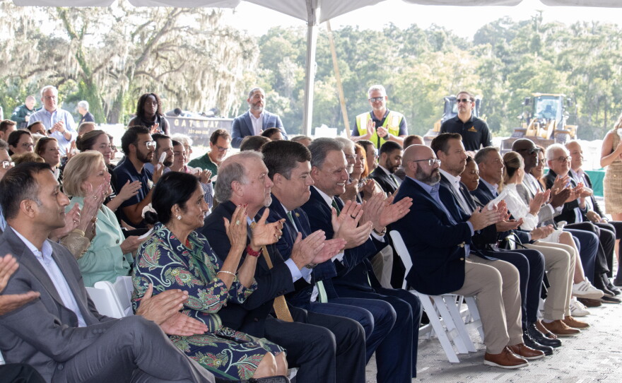 Local leaders and community members cheer during a groundbreaking ceremony for the Uptown Landing redevelopment off of Fletcher Avenue and east of North 46th Street.