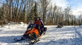 Snowmobilers on a trail