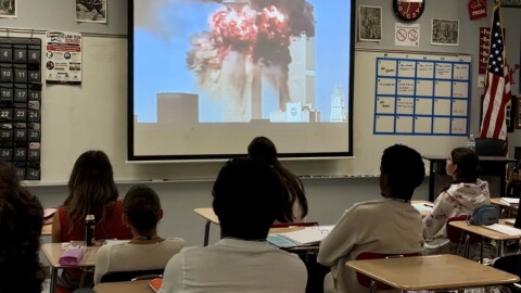 Students in AP American Government in Palm Beach Central High School watch a video compilation of videos and victim voice messages from the 9/11 terrorist attack in New York City.
