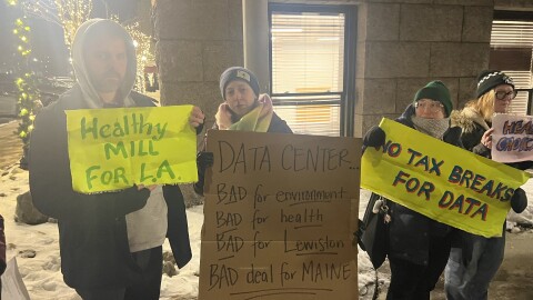 Around a dozen protesters gathered on Pine Street outside Lewiston City Hall ahead of the city council meeting on Dec. 16, 2025 to oppose a plan to build an A.I. data center in the Bates Mill complex.