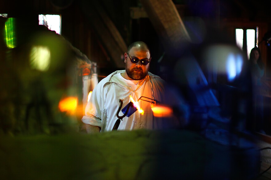 Glass blower Ron Rogers works in a replica factory near the site of the original Jamestown kiln. He practices his craft just as the colonists did, except for using gas-fueled ovens instead of wood-fired ones.