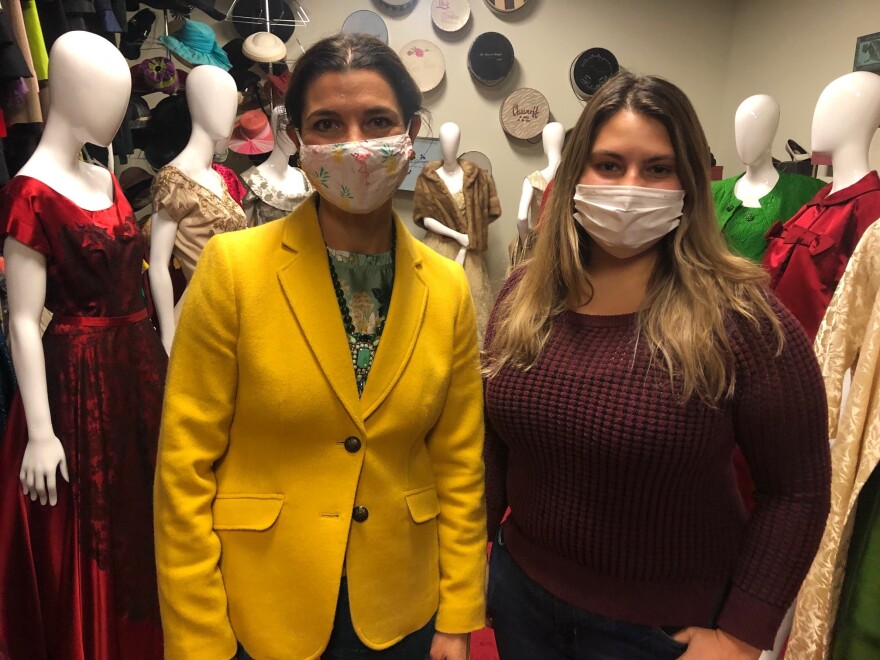 JCCC associate professor Britt Benjamin and JCCC student inside the historical fashion collection at JCCC.