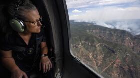 Arizona Gov. Katie Hobbs looks out of a helicopter window during her aerial tour of wildfire damage along the Grand Canyon's North Rim, Ariz., Saturday, July 19, 2025. (Joe Rondone/The Arizona Republic via AP, Pool)