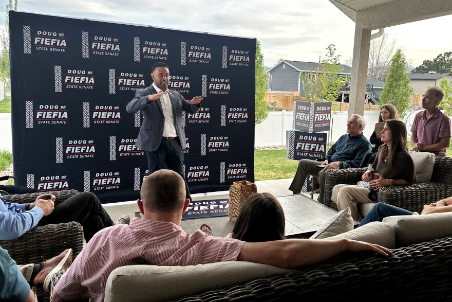 Utah State Rep. Doug Fiefia talks to Utah voters on the back deck of a house, Thursday, April 9, 2026, in Riverton, Utah. Fiefia, a Republican, has a background in technology and is running for the state senate with a pledge to tackle AI.