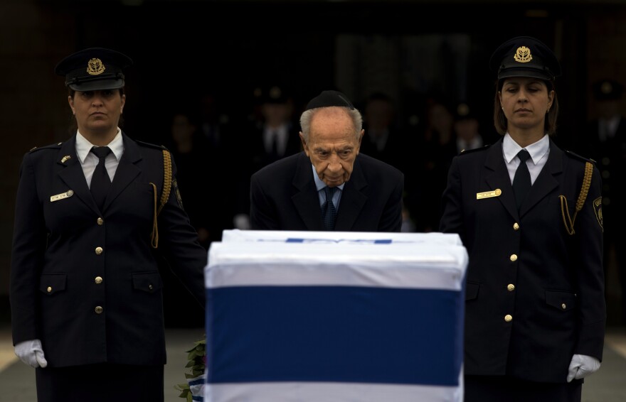 Israel's President Shimon Peres stands next the coffin of former Israeli Prime Minister Ariel Sharon at the Knesset in Jerusalem on Sunday.