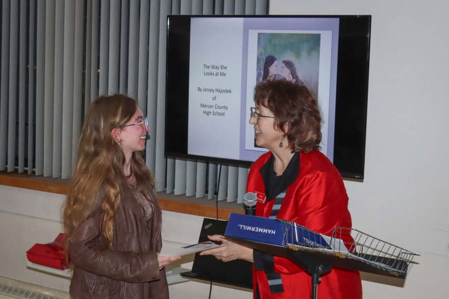 Wohlford-Metallo handing out one of the student awards for the 49th-annual High School Art Invitational in April 2026.