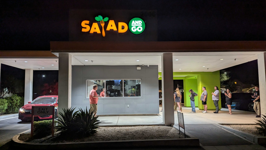 Customers lined up outside a Salad and Go location at night